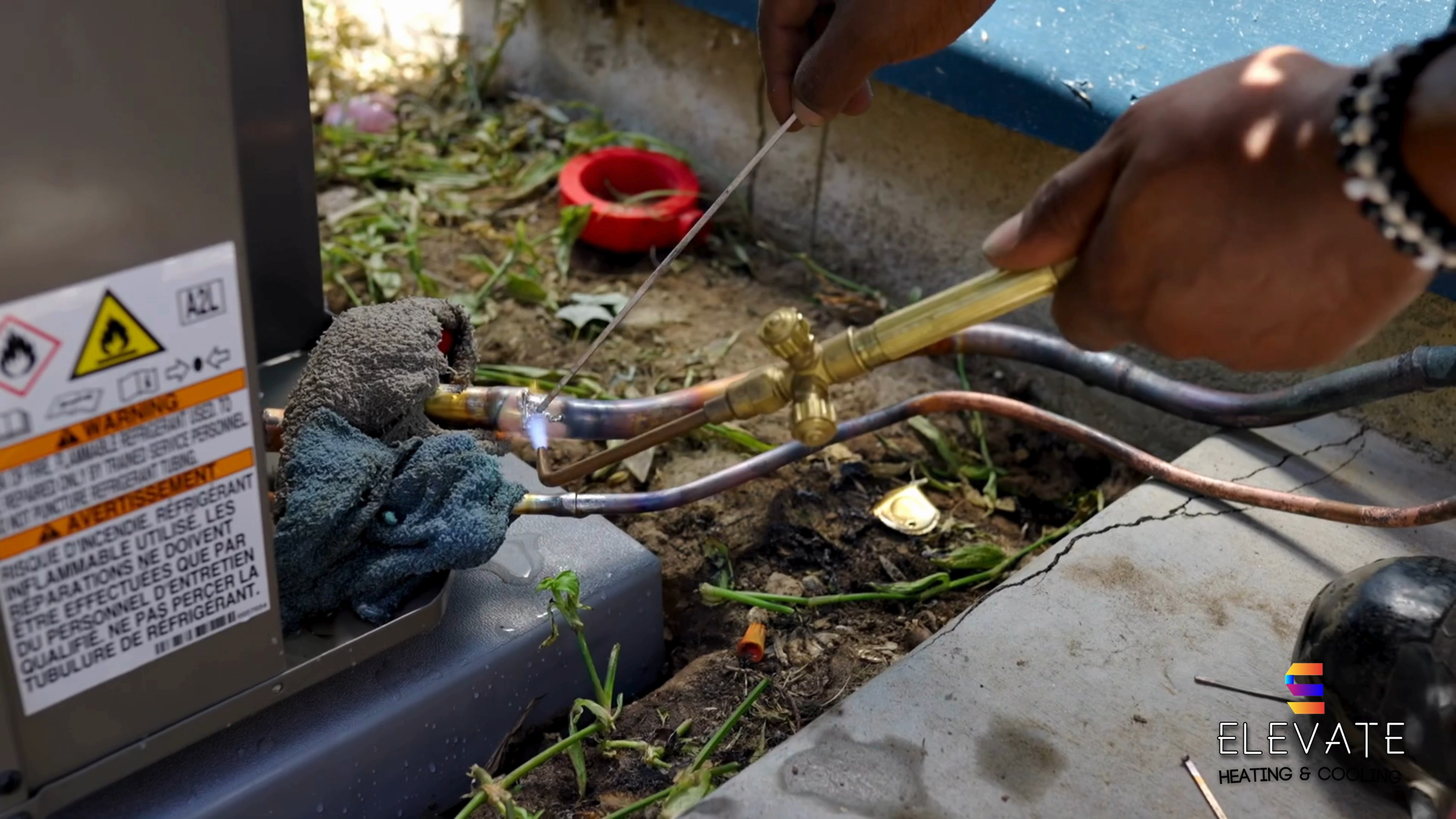 An Elevate technician brazing a refrigerant line on a job